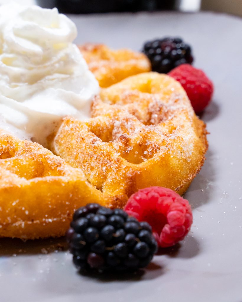 churro waffle with whipped cream and berries